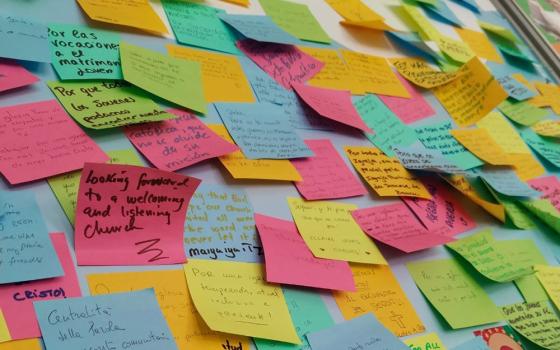 Dozens of Post-it Notes with prayers and requests from young people are seen on the wall at the Synod of Bishops' booth in a park in Lisbon, Portugal, during World Youth Day Aug. 1-6. (OSV News/Courtesy of the Synod Secretariat)