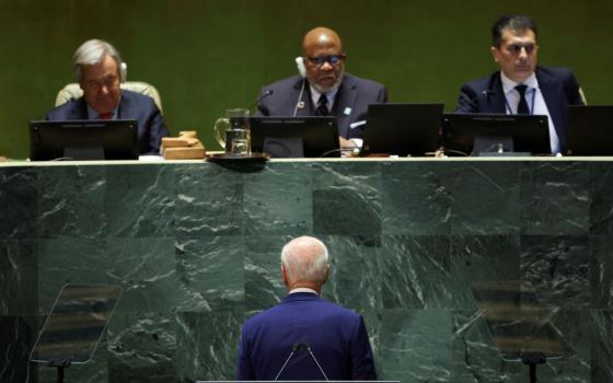 U.S. President Joe Biden looks up at the United Nations leadership including Secretary-General Antonio Guterres and General Assembly President Dennis Frances after completing his address to the 78th Session of the U.N. General Assembly in New York City, Sept. 19, 2023.