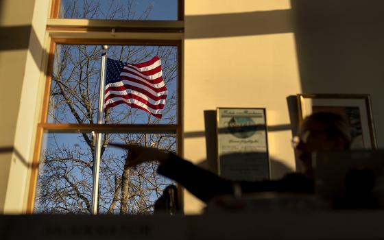 An American flag flies outside the Aspray Boat House polling site before the doors open to voters in the midterm election in Warwick, Rhode Island, Nov. 8, 2022. (AP/David Goldman)