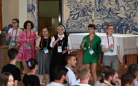 Sr. Maximiliana Şanta leading a large group through a catechetical activity during World Youth Day in Lisbon, August 2023. (Courtesy of the Sisters of the Order of St. Basil the Great)