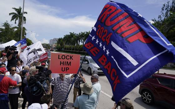 Protesters and supporters of former President Donald Trump wait for him to arrive at Trump National Doral golf resort on June 12 in Doral, Florida. (AP/Evan Vucci)