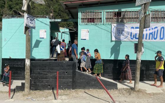 Families enter a voting center in Chinautla, on the edge of Guatemala City, in mid-August. (Courtesy of Faith in Action)