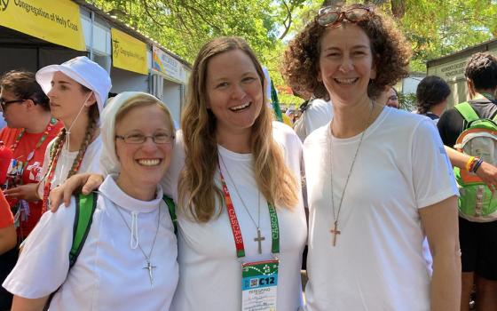 Sisters who connected via the organization Giving Voice meet in person for the first time at the City of Joy during World Youth Day in Lisbon, Portugal. From left are Apostle of the Sacred Heart Sr. Kathryn Press, and Sr. Libby Osgood and Sr. Christa Gesztesi of the Congregation of Notre Dame de Montreal. (Courtesy of Libby Osgood)