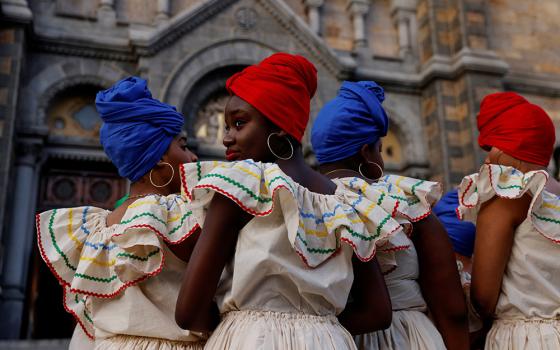 Members of a Haitian dance group in Boston wait to perform outside the Basilica and Shrine of Our Lady of Perpetual Help Oct. 16, 2021. (CNS/Reuters/Shannon Stapleton)