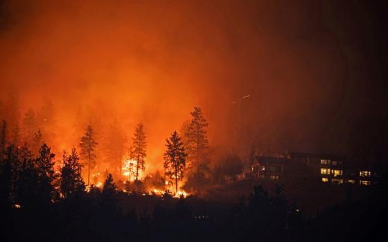 The McDougall Creek wildfire burns near homes outside the Okanagan community of West Kelowna, British Columbia, Aug. 18, 2023. (OSV News/Reuters/Chris Helgren)