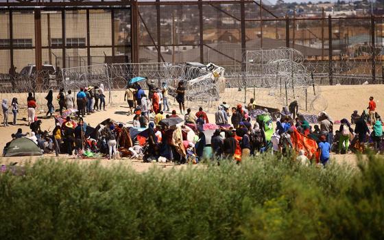Migrants, mostly from Venezuela, are seen from Ciudad Juárez, Mexico, as they gather near the U.S. border wall Sept. 24, after crossing the Rio Grande with the intention of turning themselves in to U.S. Border Patrol agents to request asylum. (OSV News/Reuters/Jose Luis Gonzalez)