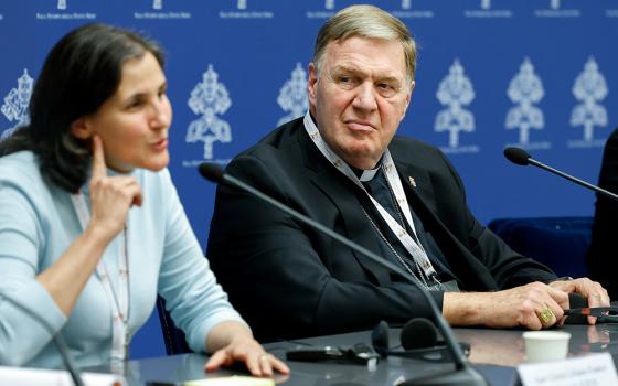 Cardinal Joseph Tobin of Newark, New Jersey, listens to Sr. Liliana Franco Echeverri, a member of the Company of Mary and president of the Latin American Confederation of Religious, as she speaks during a briefing about the assembly of the Synod of Bishops at the Vatican Oct. 10. (CNS/Lola Gomez)
