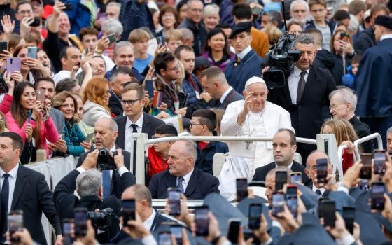 Pope Francis greets visitors from the popemobile as he rides around St. Peter's Square at the Vatican before his weekly general audience Oct. 25, 2023. (CNS photo/Lola Gomez)