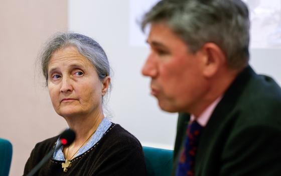 Cécile Stone, lead author of the report "Displaced by a Changing Climate: Caritas Voices on Protecting and Supporting People on the Move," listens to Alistar Dutton, Caritas Internationalis secretary general, as he speaks during a press conference launching the report in Rome Oct. 26. (CNS/Lola Gomez)