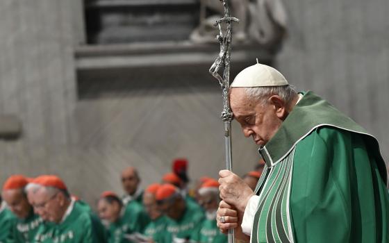 Pope Francis prays while holding a crosier during Mass in St. Peter's Basilica at the Vatican Oct. 29, 2023, marking the conclusion of the first session of the Synod of Bishops on synodality. (CNS photo/Vatican Media)