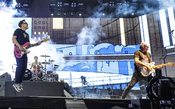 From left, Mark Hoppus, Travis Barker and Tom DeLonge of Blink-182 perform at the Coachella Music and Arts Festival at the Empire Polo Club April 24 in Indio, California. (AP/Invision/Amy Harris)