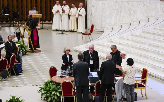 From left foreground front to camera, Sr. Nathalie Becquart, Synod of Bishops' Rapporteur Cardinal Jean-Claude Hollerich and Synod of Bishops' Secretary-General Cardinal Mario Grech attend with Pope Francis a session of the 16th general assembly of the synod of bishops in the Paul VI Hall at the Vatican, Oct. 16. (AP/Domenico Stinellis)