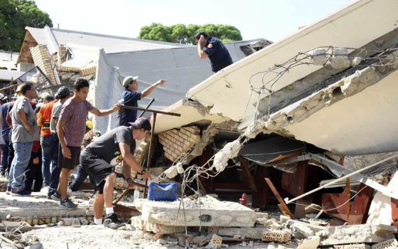 Rescue workers search for survivors amid debris after the roof of a church collapsed during a Sunday Mass in Ciudad Madero, Mexico, Oct. 1. The Bishop of the Roman Catholic Diocese of Tampico said the roof caved in while parishioners were receiving communion. (Jose Luis Tapia/El Sol de Tampico via AP)