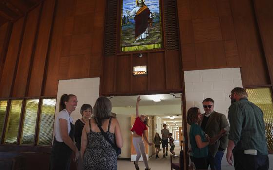 A young girl jumps to touch the doorway to the sanctuary of First Baptist Church in Mount Vernon, Illinois, on Sunday, Sept. 10. (AP/Jessie Wardarski)