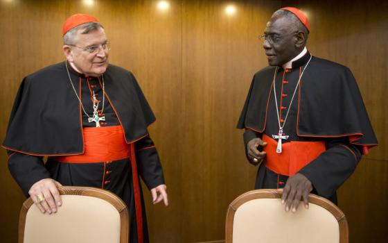 Cardinal Raymond Leo Burke, left, talks with Cardinal Robert Sarah, prefect of the Congregation for Divine Worship and the Discipline of the Sacraments, as he arrives for the presentation of his book Divine Love Made Flesh, in Rome, Wednesday, Oct. 14, 2015. Five conservative cardinals are challenging Pope Francis to affirm Catholic teaching on homosexuality and female ordination. They've asked him to respond ahead of a big Vatican meeting where such hot-button issues are up for debate.The cardinals on Mond
