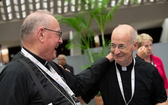 New York Cardinal Timothy Dolan and Jesuit Fr. James Martin, editor at large of America magazine, share a laugh during a break at the assembly of the Synod of Bishops in the Vatican's Paul VI Audience Hall Oct. 11. (CNS/Vatican Media)