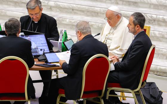 Pope Francis joins leaders of the assembly of the Synod of Bishops for a working session Oct. 23 in the Vatican's Paul VI Audience Hall. (CNS/Lola Gomez)