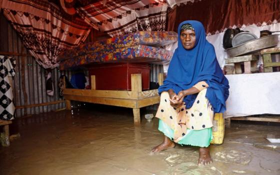 Fatima Abdi, 50, a Somali woman, sits inside her flooded makeshift shelter following heavy rains at the Al Hidaya camp for the internally displaced people on the outskirts of Mogadishu, Somalia, Nov. 6, 2023. (OSV News/Reuters/Feisal Omar)