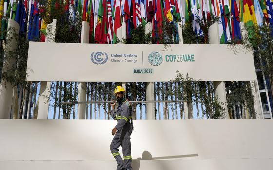 A worker sets up at the COP28 U.N. climate summit Nov. 30 in Dubai, United Arab Emirates. (AP/Rafiq Maqbool)