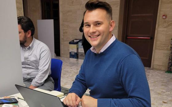 NCR Vatican correspondent Christopher White at work during the synod on synodality in Rome in October (NCR photo)