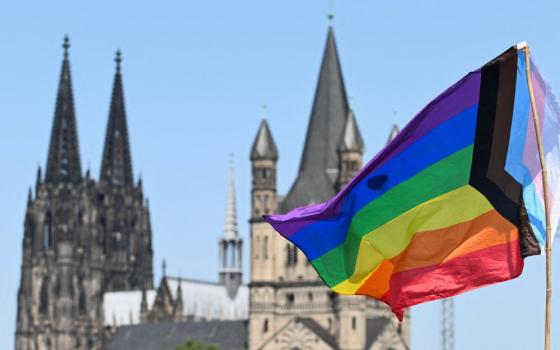 Rainbow flag with church steeples behind
