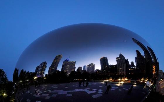 The Chicago Archdiocese announced Dec. 17 that beginning in January its nearly 400 parishes, schools, cemeteries and offices will switch to 100% renewabThe Chicago skyline is reflected on Anish Kapoor's stainless steel sculpture Cloud Gate, also known as "The Bean," in the city's Millennium Park Thursday, May 25. 