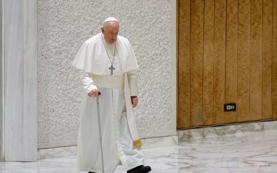 Pope Francis, walking with a cane, arrives in the Paul VI Audience Hall for his weekly general audience at the Vatican Dec. 6. (CNS/Lola Gomez)
