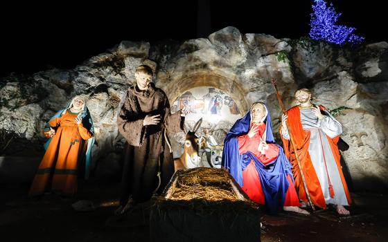 The Nativity scene is revealed and the Christmas tree is lit in St. Peter’s Square Dec. 9 at the Vatican. The creche is a reproduction of the scene in Greccio, Italy, where St. Francis of Assisi staged the first Nativity scene in 1223. The baby Jesus will be placed in the manger Dec. 24. (CNS/Lola Gomez)