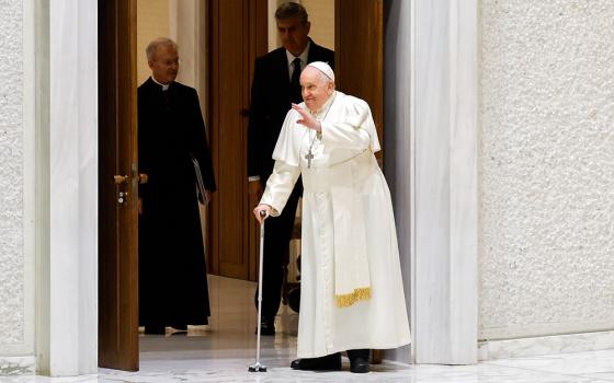 Pope Francis, walking with a cane, arrives in the Paul VI Audience Hall for his weekly general audience at the Vatican Dec. 27. (CNS/Lola Gomez)