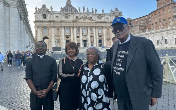 From left: Fr Willy Kingsley and St. Ann Social Justice Committee members Mary Sewell, Dolores Moore, and Ralph Moore stand in St. Peter's Square during their visit to Rome in October 2023. There they urged Vatican officials to expedite the causes of the first six African American Catholics on the path to sainthood. (Ralph Moore)