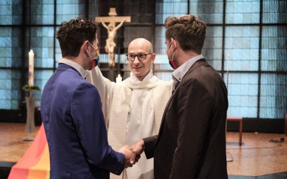 Fr. Christian Olding blesses a gay couple during a blessing service called "Love Wins" in the Church of St. Martin in Geldern, Germany May 6, 2021.