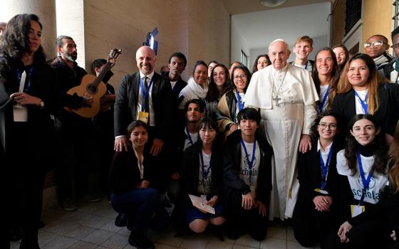 Pope Francis poses after he inaugurated the new headquarters of Scholas Occurrentes, the Vatican's foundation that works to link technology and the arts for social integration and world peace, in Rome Dec. 13, 2019. (CNS/Vatican Media)