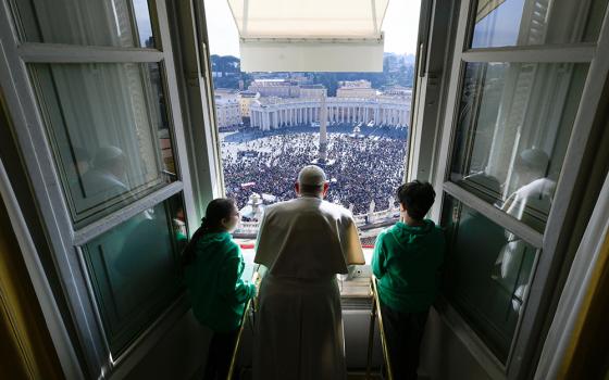 Pope Francis and young people associated with Catholic Action, a lay apostolate, join the pope as he leads the Angelus from his studio overlooking St. Peter's Square at the Vatican Jan. 28, 2024. (CNS/Vatican Media)