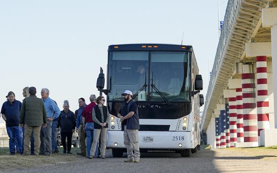Republican members of Congress arrive via bus at the Texas-Mexico border Jan. 3 in Eagle Pass, Texas. The visit to the border by about 60 congressional Republicans came as they demanded hard-line immigration policies in exchange for backing President Joe Biden's emergency wartime funding request for Ukraine. (AP/Eric Gay)