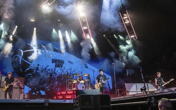 From left, Jason White, Billie Joe Armstrong, Tré Cool, and Mike Dirnt of Green Day perform on at the Lollapalooza Music Festival on July 31, 2022, at Grant Park in Chicago. (AP/Invision/Amy Harris)