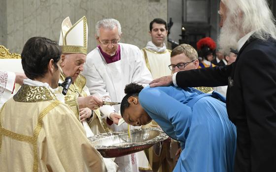 Pope Francis baptizes Auriea Harvey, a woman from the United States, during the Easter Vigil Mass in St. Peter's Basilica at the Vatican in this file photo from April 8, 2023. (CNS/Vatican Media)