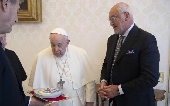 Bruno Abate, founder and president of Recipe for Change, gives Pope Francis a painting of Mary and the child Jesus made by an inmate at Chicago's Cook County Jail during a meeting in the library of the Apostolic Palace at the Vatican Feb. 9, 2024. (CNS/Vatican Media)