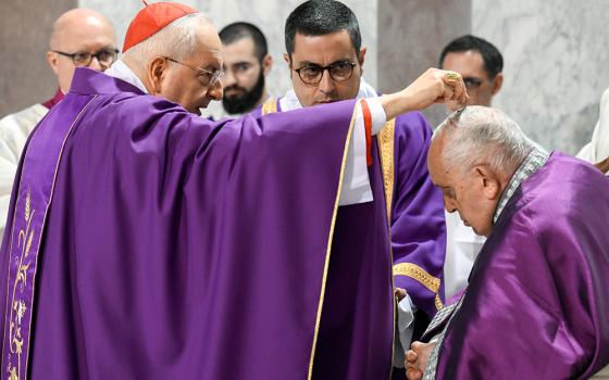 Cardinal Mauro Piacenza, head of the Apostolic Penitentiary, sprinkles ashes on Pope Francis' head during Ash Wednesday Mass at the Basilica of Santa Sabina in Rome Feb. 14, 2024. (CNS/Vatican Media)