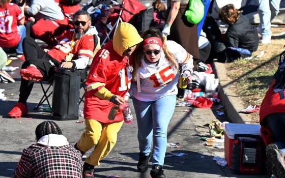 Fans leave the area after gun shots were fired in Kansas City, Mo., after the celebration of the Kansas City Chiefs winning Super Bowl LVIII. The shooting at the end of the parade left one dead and at least 15 injured, while sending terrified fans running for cover. (OSV News photo/Kirby Lee-USA TODAY Sports via Reuters)