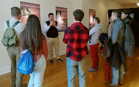 Attendees at the 2024 New York Encounter, a Feb. 16-18 event organized by the Catholic lay movement Communion and Liberation, take a guided tour of one of the exhibitions. (Jeannine Pitas)