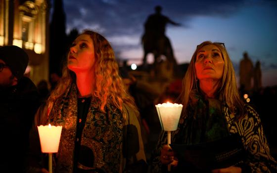 Women hold candles as they attend a vigil in memory of late Russian opposition leader Alexei Navalny at the Campidoglio (Capitoline Hill) in Rome Feb. 19, 2024. (OSV News/Reuters/Yara Nardi)