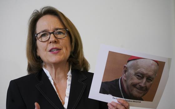 Anne Barrett Doyle, co-director of BishopAccountability.org, holds a photo of ex-Cardinal Theodore McCarrick during a press conference in Rome, Monday, Feb. 17, 2020, on the occasion of the first anniversary of Pope Francis' summit on clergy abuse. (AP/Andrew Medichini)
