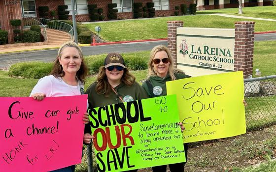 Participants in a protest display signs outside the grounds of La Reina, a high school and middle school run by the Sisters of Notre Dame in Thousand Oaks, California. The protest was organized by the group Save La Reina to prevent the closure of La Reina. (Tom Hoffarth)