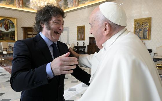 In this image distributed by Vatican Media, Argentine President Javier Milei, left, cheers at Pope Francis as they meet in the pontiff's studio at The Vatican for a private audience Feb. 12, 2024. (Vatican Media via AP, HO)
