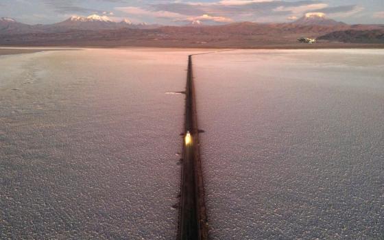 A car drives down a road through the Salar de Atacama salt flat near the Albemarle lithium mine in Chile, on April 17, 2023. 