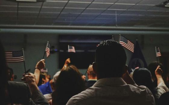 People hold small American flags