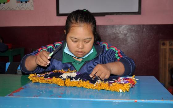 A student makes a mat at the vocational class at Navjyoti Centre, in Kathmandu, Nepal.