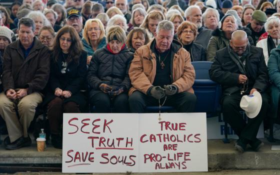 People pray rosary outside US Bishops Conference meeting in Baltimore.