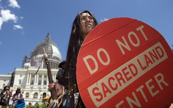 An Apache activist dancer performs in a rally to save Oak Flat, land near Superior, Ariz., sacred to Western Apache tribes, in front of the U.S. Capitol in Washington, July 22, 2015. An Apache group that has fought to protect land it considers sacred from a copper mining project in central Arizona suffered a significant blow March 1, 2024, when a divided federal court panel voted 6-5 to uphold a lower court's denial of a preliminary injunction to halt transfer of land for the project. (AP/Molly Riley, File)