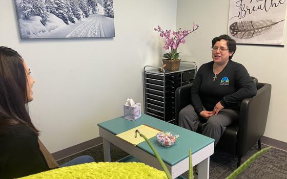  Sr. Veronica Fajardo, who provides counseling services at no cost to clients of Holy Cross Ministries, speaks with a client. (Courtesy of Lauren Fields/Holy Cross Ministries)
